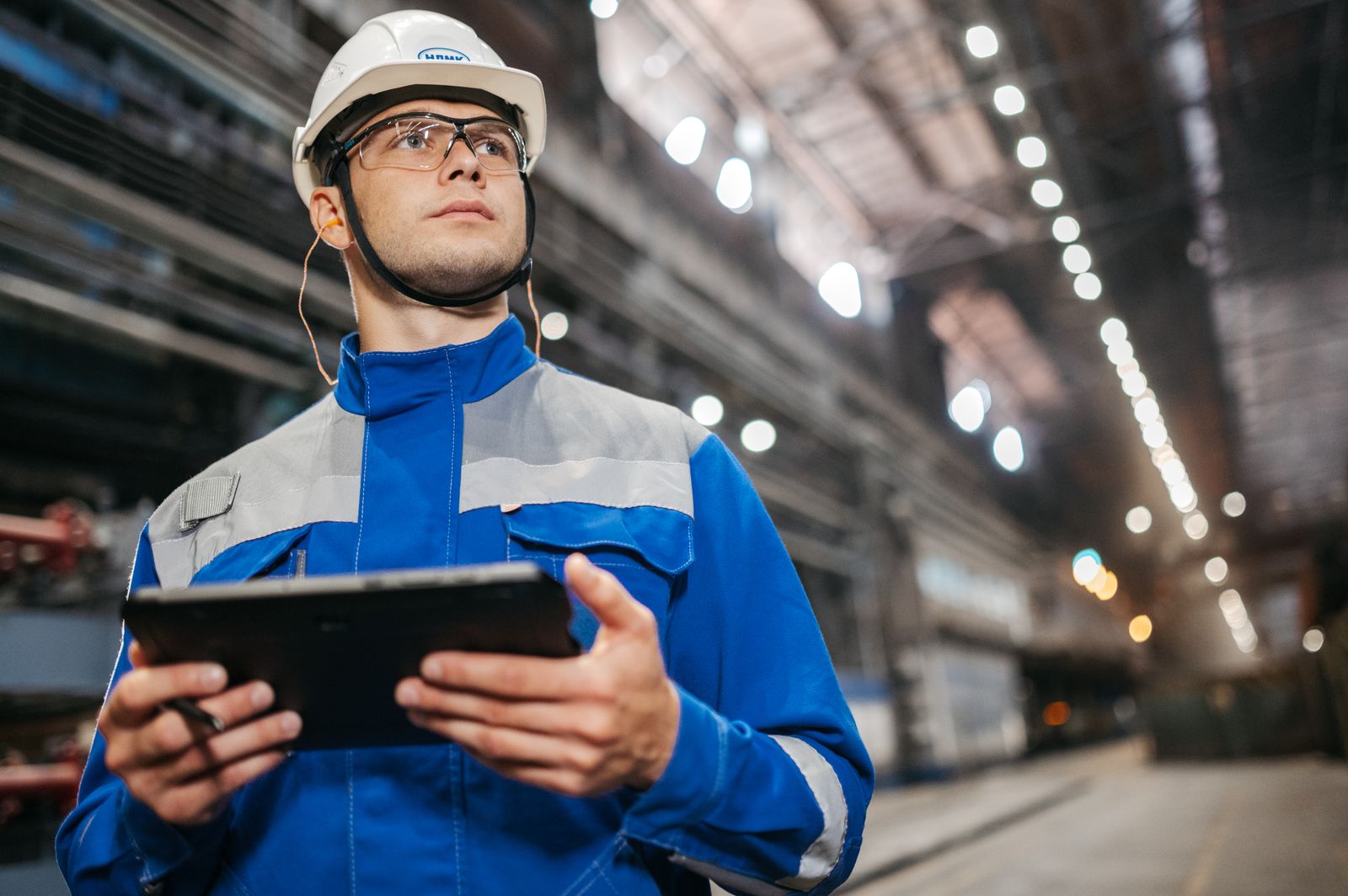 Operations professional reviewing a digital system on a tablet